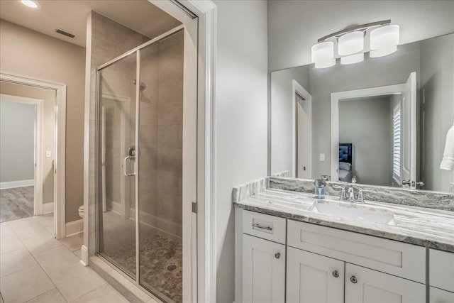 full bath featuring tile patterned flooring, visible vents, a stall shower, and vanity