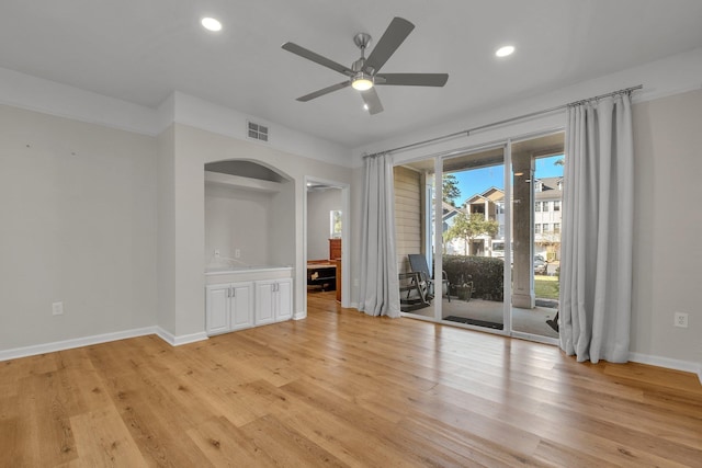 unfurnished living room featuring ceiling fan and light wood-type flooring