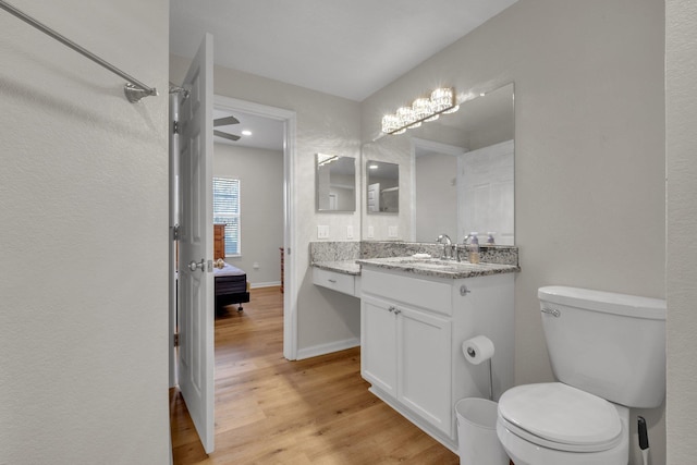 bathroom featuring hardwood / wood-style floors, vanity, and toilet