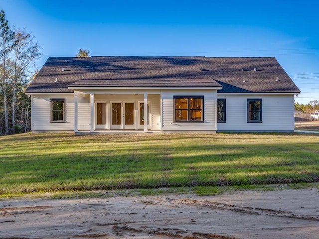 back of house with a yard and french doors