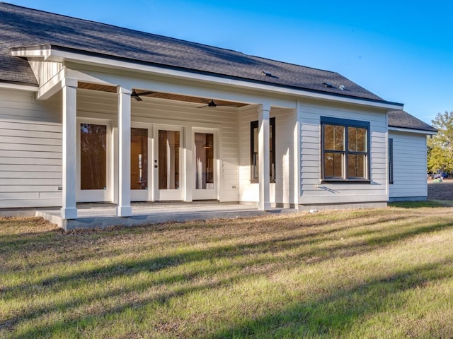 rear view of house with a lawn, ceiling fan, and a patio area