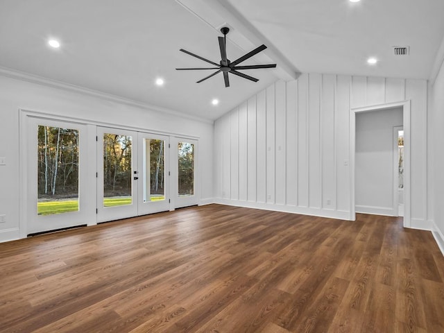 unfurnished living room featuring ceiling fan, dark hardwood / wood-style floors, a healthy amount of sunlight, and vaulted ceiling with beams