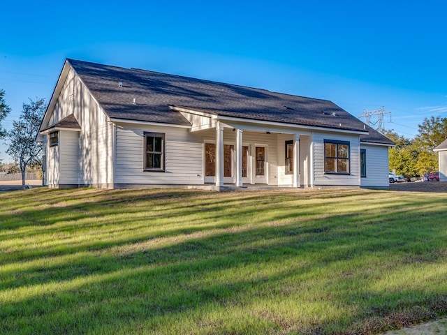 back of house with a lawn