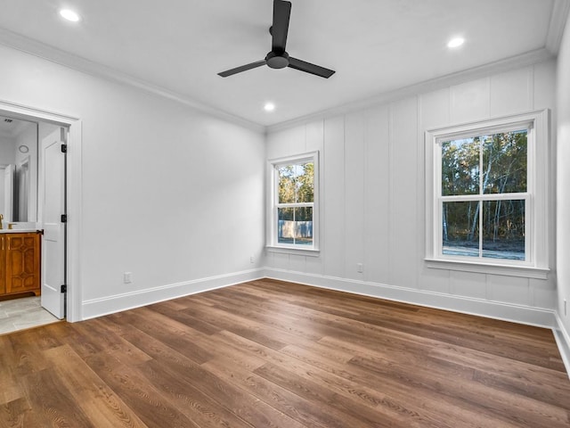 spare room featuring crown molding and a healthy amount of sunlight