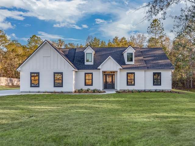 modern farmhouse style home with a front lawn