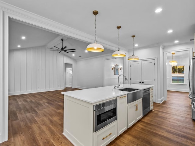 kitchen with white cabinetry, a center island with sink, stainless steel appliances, pendant lighting, and sink