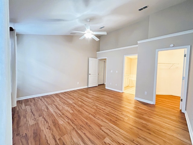 9321 Royal Troon Dr, Tallahassee, FL 32312 - unfurnished bedroom featuring high vaulted ceiling, a walk in closet, baseboards, light wood finished floors, and ensuite bath