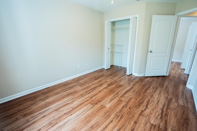 9321 Royal Troon Dr, Tallahassee, FL 32312 - unfurnished bedroom featuring wood finished floors, baseboards, and a closet