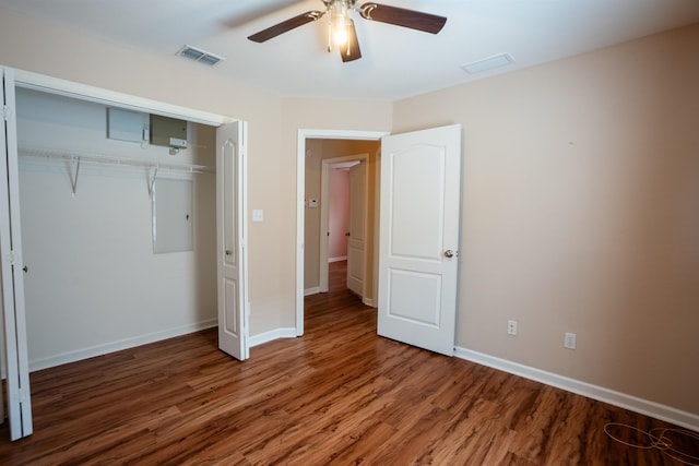 9321 Royal Troon Dr, Tallahassee, FL 32312 - unfurnished bedroom with wood finished floors, a closet, baseboards, and a ceiling fan