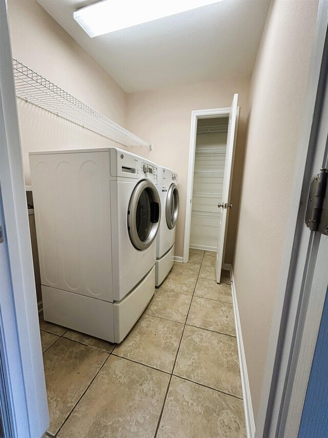 9321 Royal Troon Dr, Tallahassee, FL 32312 - clothes washing area featuring separate washer and dryer, light tile patterned floors, and baseboards