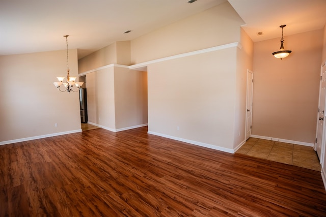 9321 Royal Troon Dr, Tallahassee, FL 32312 - empty room featuring wood finished floors, a chandelier, and baseboards