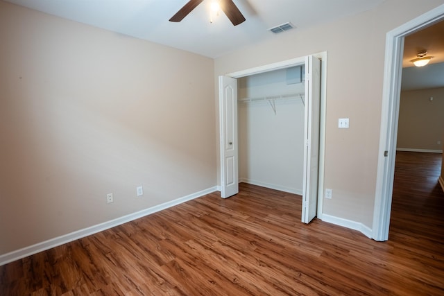 9321 Royal Troon Dr, Tallahassee, FL 32312 - unfurnished bedroom with wood finished floors, baseboards, a closet, and a ceiling fan