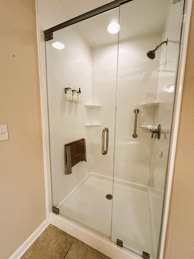 9321 Royal Troon Dr, Tallahassee, FL 32312 - bathroom featuring a shower stall, tile patterned floors, and baseboards