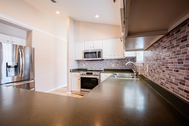 9321 Royal Troon Dr, Tallahassee, FL 32312 - kitchen with appliances with stainless steel finishes, a sink, dark countertops, white cabinetry, and tasteful backsplash