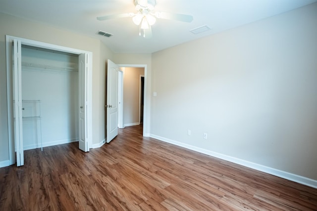 9321 Royal Troon Dr, Tallahassee, FL 32312 - unfurnished bedroom featuring wood finished floors, a closet, baseboards, and a ceiling fan