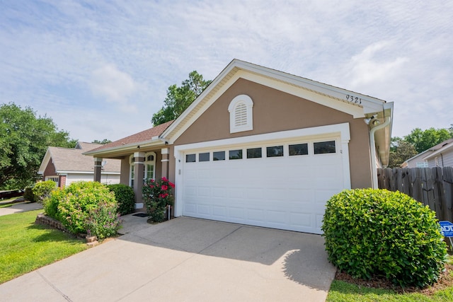 9321 Royal Troon Dr, Tallahassee, FL 32312 - ranch-style house featuring a garage, concrete driveway, stucco siding, and fence