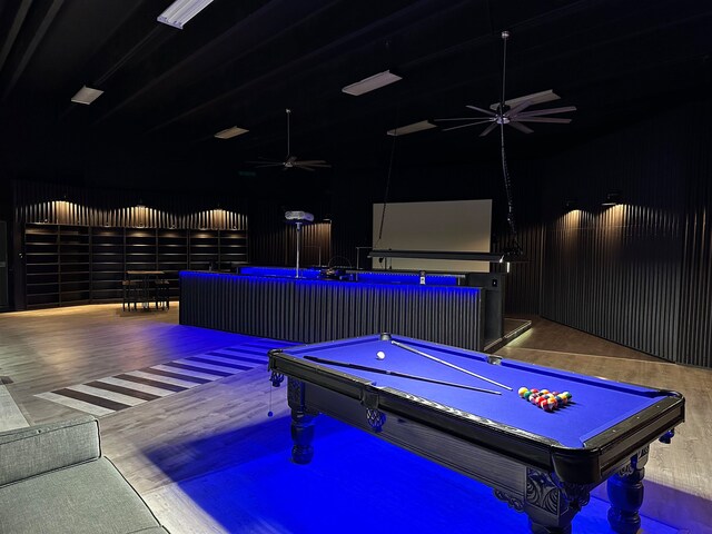 rec room featuring pool table, hardwood / wood-style floors, and a high ceiling