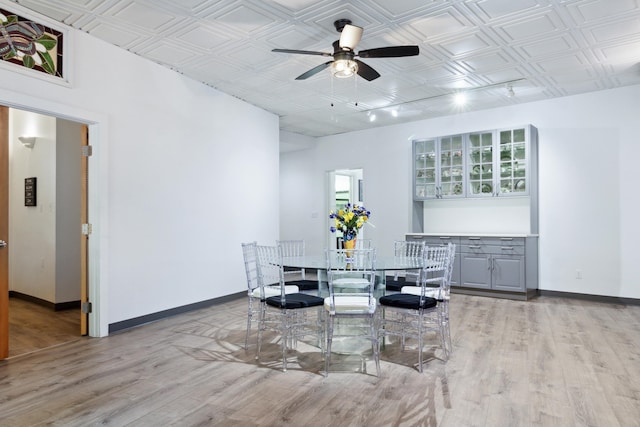 dining space featuring light hardwood / wood-style floors and ceiling fan