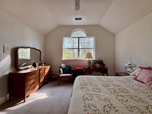 bedroom featuring lofted ceiling, visible vents, a ceiling fan, and light carpet
