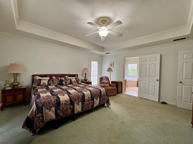 carpeted bedroom with visible vents, a raised ceiling, ceiling fan, and crown molding