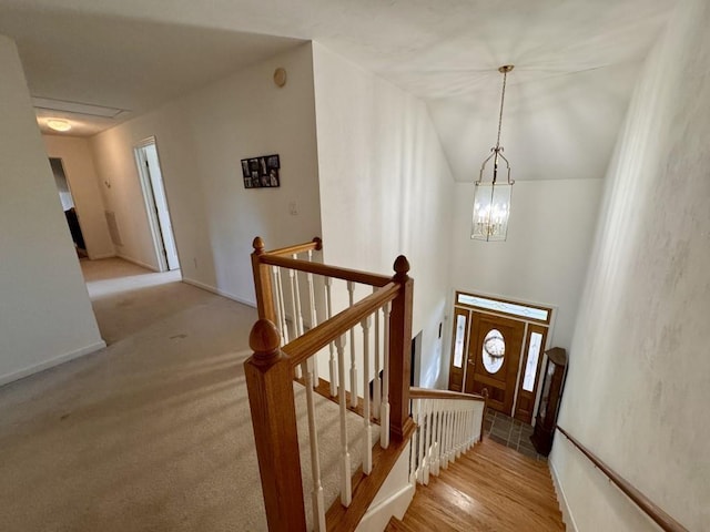 entryway featuring vaulted ceiling and a chandelier