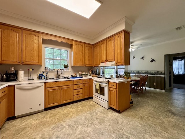 kitchen featuring white appliances, brown cabinetry, a sink, visible vents, and crown molding