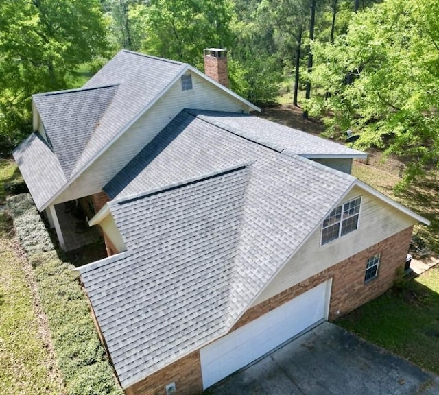 birds eye view of property with a wooded view