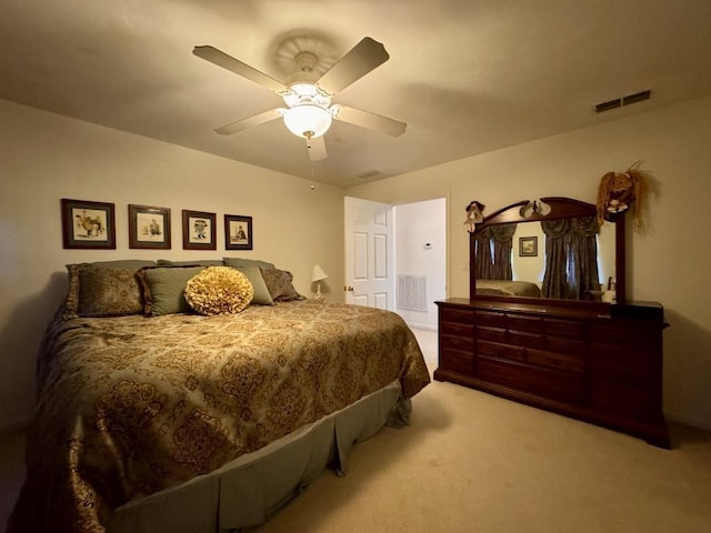 carpeted bedroom with visible vents, a ceiling fan, and baseboards