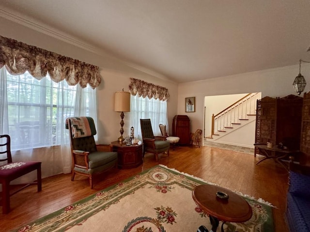 living area with stairway, wood finished floors, and crown molding