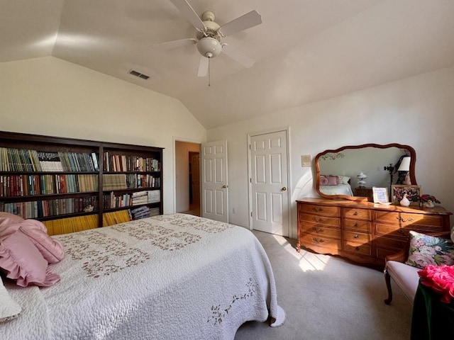 carpeted bedroom featuring visible vents, ceiling fan, and lofted ceiling