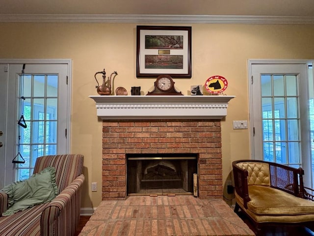 sitting room with baseboards, ornamental molding, and a fireplace