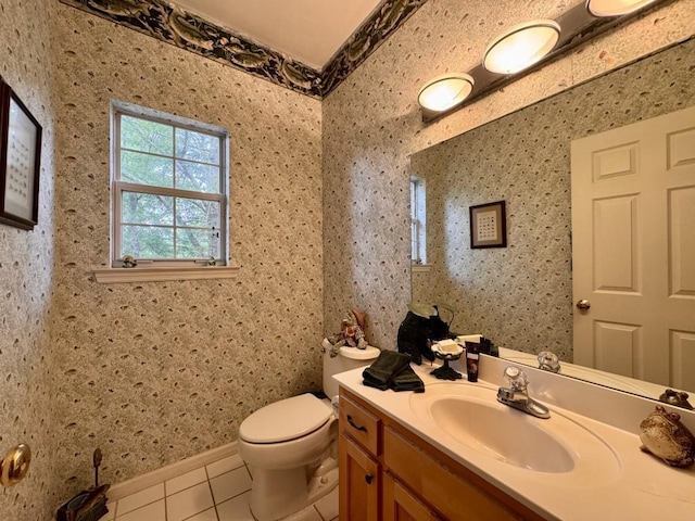 half bath with tile patterned floors, toilet, and vanity