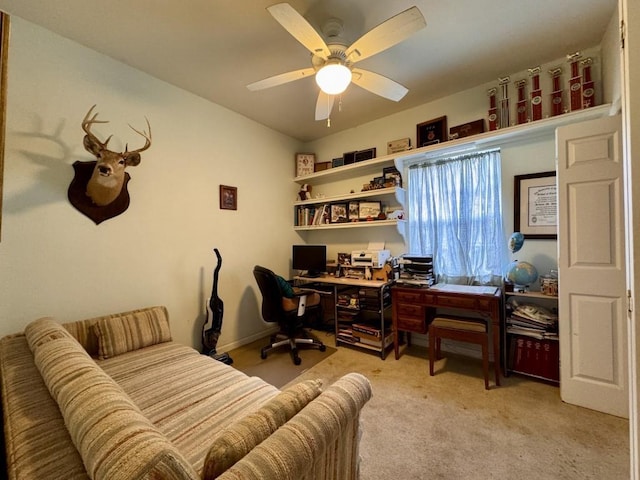 office area with a ceiling fan and light colored carpet