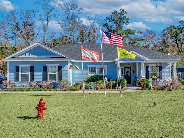 view of front of property with a front yard and covered porch