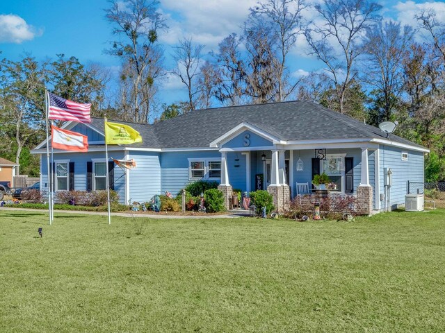 view of front of property featuring central AC unit, a porch, and a front lawn