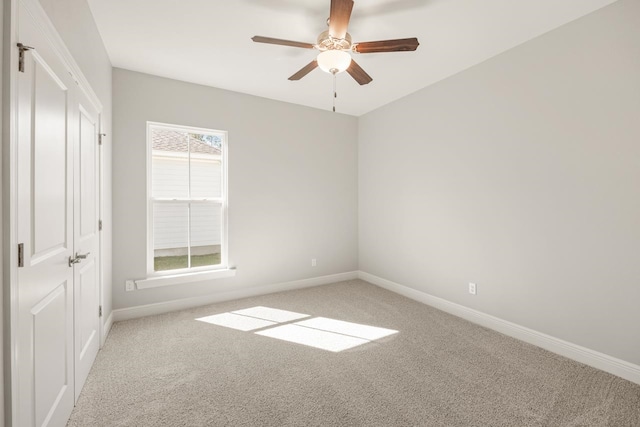 spare room with light carpet and ceiling fan