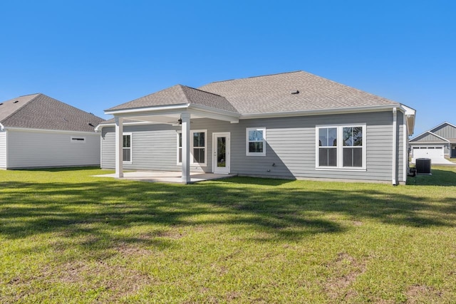 rear view of house with central AC, ceiling fan, a yard, and a patio