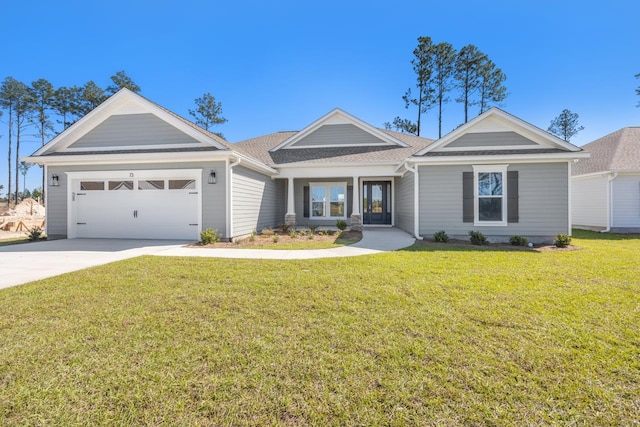 view of front of house with a garage and a front yard