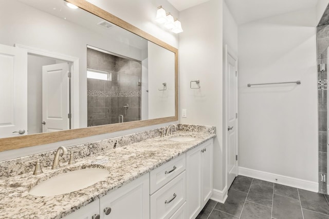 bathroom featuring tile patterned flooring, vanity, and a shower with door