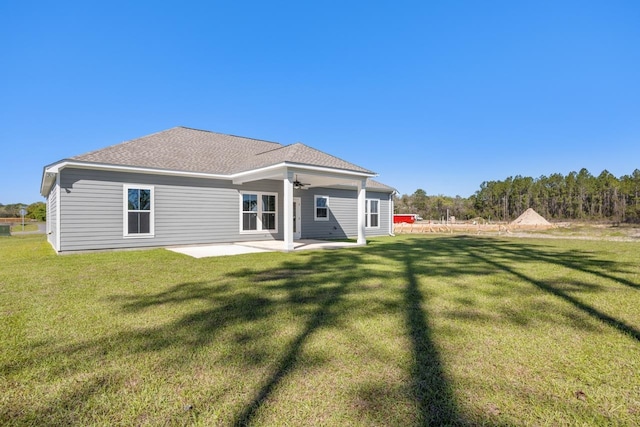 rear view of property with a patio, ceiling fan, and a lawn