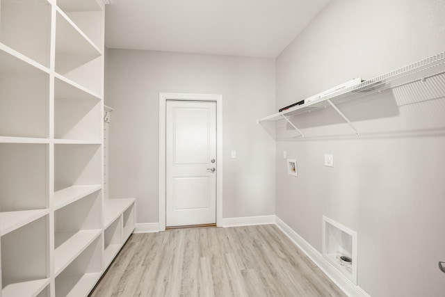 washroom with hookup for a washing machine and light hardwood / wood-style flooring