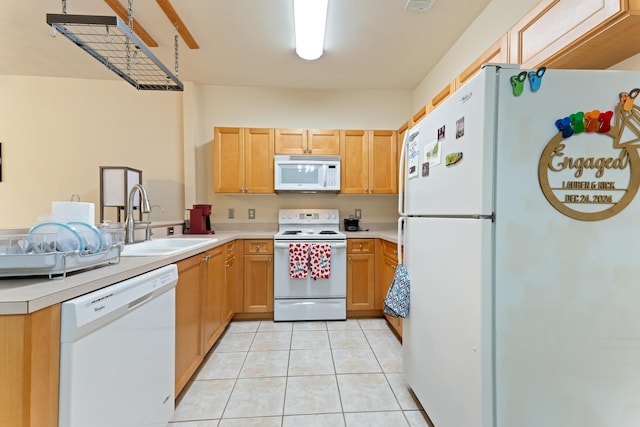 3400 Old Bainbridge Rd Unit 108, Tallahassee, FL 32303 - kitchen with light countertops, light tile patterned floors, a peninsula, white appliances, and a sink