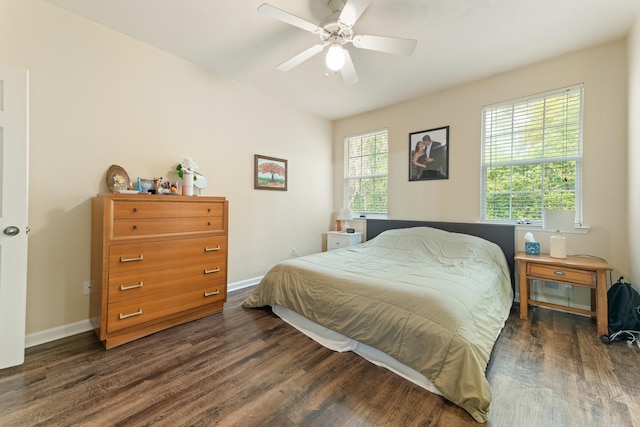 3400 Old Bainbridge Rd Unit 108, Tallahassee, FL 32303 - bedroom with dark wood-style floors, a ceiling fan, and baseboards