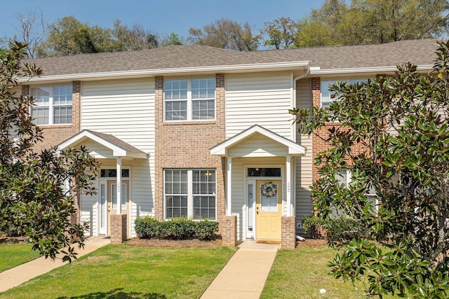 3400 Old Bainbridge Rd Unit 108, Tallahassee, FL 32303 - view of front facade featuring brick siding, a front yard, and a shingled roof