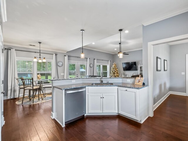 kitchen with dishwasher, white cabinetry, sink, and a wealth of natural light