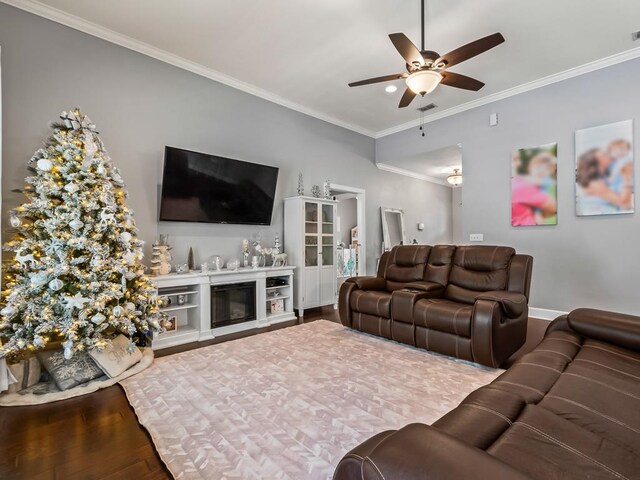 living room with crown molding, hardwood / wood-style floors, and ceiling fan