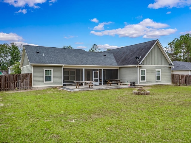 back of house with a sunroom, a yard, and a patio