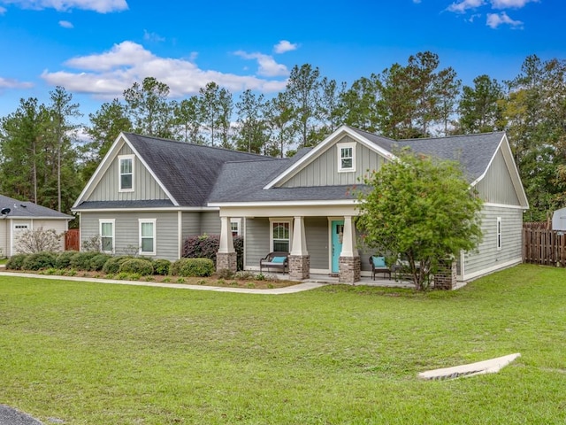 craftsman-style house featuring covered porch and a front yard