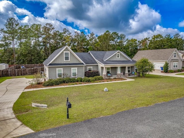 view of front of home featuring covered porch and a front yard