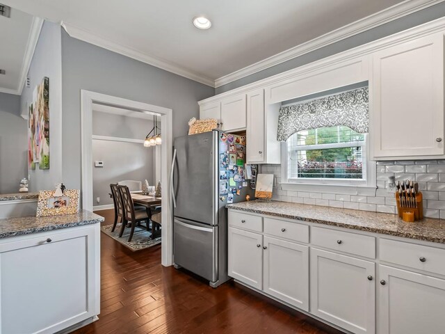 kitchen with stainless steel fridge, white cabinetry, dark hardwood / wood-style flooring, and light stone counters